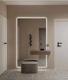 a bathroom with a sink, mirror and stool next to the door that leads to another room