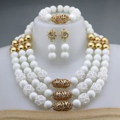 a white and gold beaded necklace with matching earrings