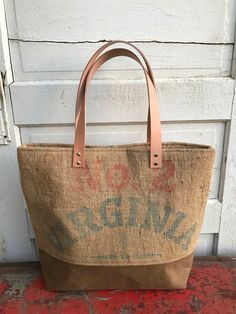 a brown and tan bag sitting on top of a door