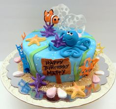 a birthday cake decorated with an ocean theme