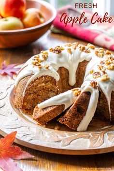 fresh apple cake with white icing on a plate