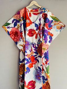 This Beautiful Indian Cotton Caftan Or Can Be Called As Tunic Is Made With Super Fine Quality Cotton And Designs Have Been Crafted By Hand Prints. Measurements :- Size - Free Size  Length -138 Cm / 54 Inches Bust/Chest Size - 87 CM/ 34 Inches Fabric - 100% Cotton Pattern - Floral Kaftan Has Adjustable Drawstring Waist To Loose Or Tight , Kaftan Has V Shape Neck Which Is 8" Inches Deep. Kaftan Is Multi-Purpose And Can Be Worn As A Cover Up At The Beach ,Lounge Wear ,Sleepwear ,Pregnant Women Hospital Gown For Newly Moms ,Maxi Dress ,Free Dress Etc . Indian Kaftan Very Comfortable To Wear In Both Hot Or Cold Weather. Kaftan Is Super Comfortable .It Will Be Loose And Free Flowing And Fabric Is Very Soft With Vibrant Color Note :-Due To Different Monitor Setting Colors May Be Little Vary To Or White V-neck Floral Print Kaftan, Multicolor Tropical Cotton Dress, Tropical Multicolor Cotton Dresses, Summer Multicolor Kaftan With Kimono Sleeves, Summer Multicolor Tunic Kimono, Multicolor Short Sleeve Kaftan For The Beach, Beach Kaftan With Short Sleeves In Multicolor, Multicolor Beach Kaftan, Multicolor Short Sleeve Kimono For Beach Cover-up