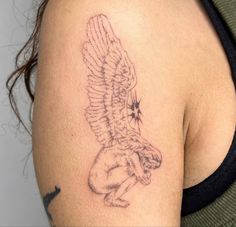 a woman's arm with a tattoo on it that has an eagle in the middle