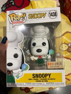 a snoopy pop vinyl figure in a box