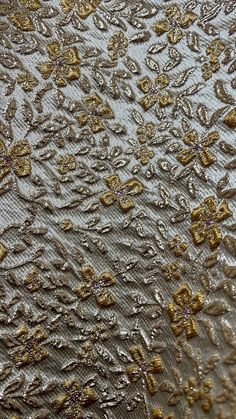 closeup of the fabric with gold and silver flowers on it's back side