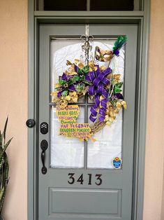 the front door is decorated with purple and yellow flowers