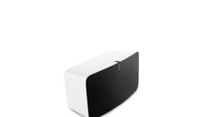 a white and black speaker sitting on top of a table