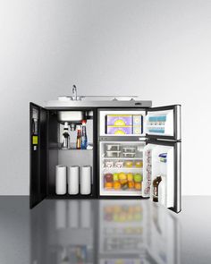 an open refrigerator sitting on top of a shiny floor next to a sink and fridge