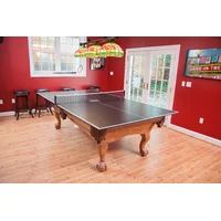 a ping pong table is in the middle of a room with red walls and hardwood floors