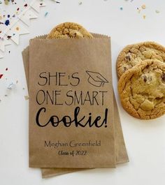 there is a bag with some cookies on it next to a cookie that says she's one smart cookie