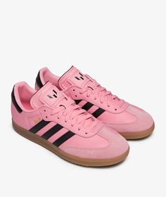 a pink adidas sneakers with black stripes