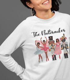 This unisex ADULT sweatshirt is inspired by The Nutcracker Ballet. Created just in time for the holiday season, it features brown ballerinas and other known characters like the Rat King, Clara, and the Sugar Plum Fairy. This soft crew neck top offers a loose fit and comfortable feel. The material is 50% cotton and 50% polyester; however, fabric content may vary based on the color you select. Be sure to view matching products to create your own gift set too. Visit The Trini Gee for more: https:// Long Sleeve Tops With Custom Print For Winter, Winter Custom Print Tops With Relaxed Fit, Winter Tops With Custom Print And Relaxed Fit, Holiday Cotton Tops With Character Print, Holiday Cotton Top With Character Print, Cotton Top With Character Print For Holidays, Custom Print Cotton Tops, Cotton Tops With Custom Print For Winter, Holiday Crew Neck Top With Character Print