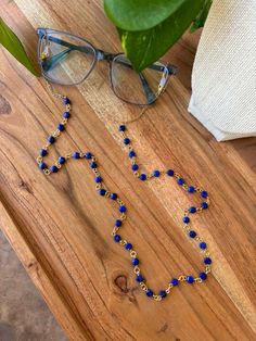 Lapis Lazuli glasses chain. This chain is made with Lapis Lazuli stones and gold plated stainless steel chain. The hooks are stainless steel and will come with two rubber eyeglass holders. These measure 29 inches long.  Please note that each stone is unique and can vary in size, shape, color, and detail. These stones are handpicked from local sellers. Follow my socials for updates, discounts, and more! Facebook: https://www.facebook.com/profile.php?id=61556585283863&mibextid=PtKPJ9 Instagram: ht Adjustable Delicate Chain Glass Necklace, Glass Necklaces With Gold Chain For Gift, Party Jewelry With Gold Chain And Glass, Party Jewelry With Glass And Gold Chain, Party Gold Chain Glass Jewelry, Adjustable Gold Glasses Chains With Lobster Clasp, Gold Chain Glasses Chains Made Of Glass For Gift, Adjustable Gold Glass Chain For Glasses, Adjustable Delicate Gold Glasses Chain