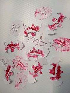 several pieces of paper with lipstick imprints on them