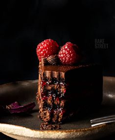 a piece of chocolate cake with raspberries on top