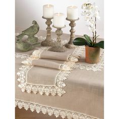 a table topped with candles and napkins next to a potted plant