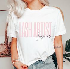 a woman with blonde hair wearing a white t - shirt that reads, lashes artist imagine