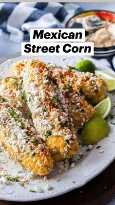 corn on the cob is served with limes and parmesan cheese for garnish