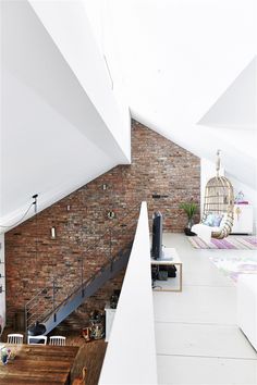 an open loft space with exposed brick walls