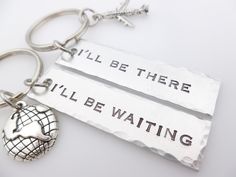 two key chains with words on them that say, i'll be there all be waiting