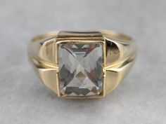 This Retro Era ring is full of refined sophistication! The white topaz at the center is pineapple cut for maximum sparkle and shine. Sleek shoulders and subtle milgrain on the bezel setting are particularly nice details! Metal: 10K Yellow Gold Gem: White Topaz approximately 4.00 Carats Gem Measurements: 7.9 x 9.8 mm, Rectangle Pineapple Cut Ring Size: 10.25 Marks: "10K" Stamped on the inside band Retro Era, White Topaz, Eternity Bands, Bezel Setting, Gold Ring, The White, Topaz, Pineapple, Gold Rings