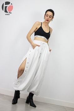 "JONES SPORT PANTS | PDF Sewing Pattern Wide leg sports pant pattern with snaps opening on the sides. Influence of basketball. It is a high-waisted pants with elastic and drawstring. It also has side pockets and elastic at the bottom of the legs. 6 DIFFERENT SIZES | 36 - 38 - 40 - 42 - 44 - 46 - Check the size chart in the product images. - If you have doubts between two sizes pick the bigger one and adjust the pattern where needed. THIS GARMENT IS ADJUSTABLE SO YOU CAN ADD 10 CM EXTRA IN THE CH Pattern Parachute Pants, Harlem Pants Pattern, Free Sweatpants Sewing Pattern, Cargo Pant Sewing Pattern, Parachute Pants Sewing Pattern, Barrel Pants Sewing Pattern, Harlem Pants, Slip Dress Pattern, Rave Pants