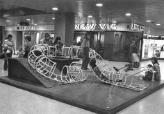 black and white photograph of people in an airport