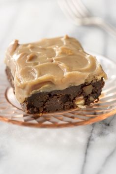 a close up of a piece of cake on a plate with frosted icing