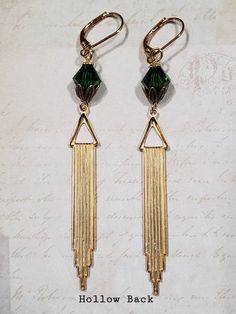 Textured Front, Hollow BackThese Art Deco style earrings feature beautiful green Swarovski crystals and long stamped brass Deco style pendants.The brass pendants have a ribbed texture on the front and the hollow reverse on the back (SEE 2nd PHOTO).The earrings measure 3 1/4 inches long and hang from gold plated leverback ear wires.ABOUT THIS COLLECTIONWhat are the three style essentials Jazz Age flappers like Clara Bow, Louise Brooks, and Zelda Fitzgerald have in common? Red lipstick, bobbed hai Vintage Brass Earrings For Evening, Art Deco Dangle Earrings For Vintage Events, Art Deco Dangle Earrings For Formal Occasions, Gold Gatsby Style Jewelry Gift, Handmade Art Deco Jewelry For Party, Art Deco Metal Earrings For Evening, Art Deco Drop Earrings For Evening, Art Deco Dangle Jewelry For Vintage Events, Art Deco Dangle Jewelry For Party