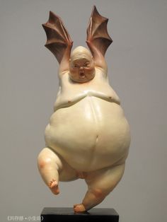 a figurine of a flying creature on a black base