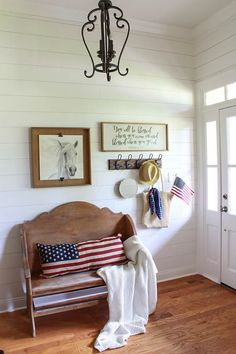 a wooden bench sitting on top of a hard wood floor next to a white wall