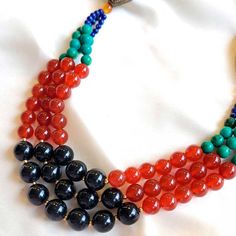 This stunning Multi-Gemstone Necklace features a unique blend of veined black jade, carnelian and other gemstones. Crafted with artistry and carefully selected natural stones, it's sure to become your favorite statement piece. Veined Black Jade (10mm) Carnelian (8mm) Turquoise (6mm) Lapis Lazuli (3mm) Freshwater Pearls (3mm) Goldfilled clasp and beads Brass details Length: 24" Black Agate Beaded Necklace With Gemstones, Elegant Multicolor Jewelry With Black Beads, Black Onyx Beads Jewelry, Round Onyx Bead Jewelry, Black Agate Round Bead Necklaces, Multicolor Carnelian Jewelry With Polished Beads, Black Agate Bead Necklaces, Polished Onyx Bead Necklace, Onyx Beads Jewelry Gift