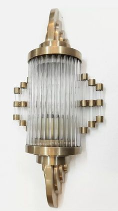 an antique brass and glass wall light on a white wall with no lights in it