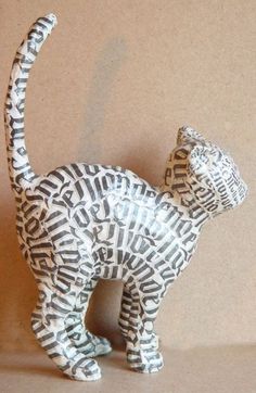 a small ceramic cat made to look like it is walking