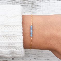 "This hand made bracelet showcases a stunning selection of blue topaz rondelles, centered on a dainty but durable chain in your preferred finish. This makes a wonderful gift for someone with a December birthday. Bracelet Size Guide: Petite: 6.5\"-7\" Average (fits most wrists): 7-8\" Large: 8-8.5\" Adjustable: 6.5\" bracelet with attached 1.5\" extender chain To find your bracelet size, simply measure the circumference of your wrist by wrapping a string around it and measuring the length of the Delicate Blue Bracelets For Everyday, Blue Dainty Birthstone Bracelets, Dainty Blue Faceted Beaded Bracelets, Minimalist Everyday Blue Topaz Jewelry, Minimalist Blue Bracelet With Delicate Chain, Blue Dainty Crystal Bracelet Gift, Dainty Blue Crystal Bracelet Gift, Everyday Blue Bracelet With Adjustable Chain, Blue Adjustable Chain Bracelet For Everyday