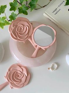 three rose shaped mirrors on top of a table