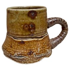 a brown mug with two handles on it