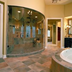 a large bathroom with a walk in shower and jacuzzi tub