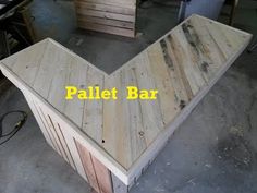 the pallet bar is made out of wood and has an arrow shape on it