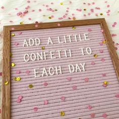 a sign that says, add a little confetti to each day on it