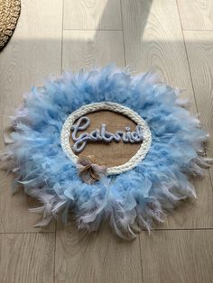 a blue and white wreath with the word gabor written on it