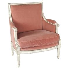 an upholstered chair with pink fabric and white trim on the armrests