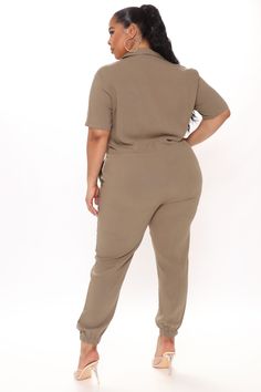 Available In Khaki And Olive. Jumpsuit Button Front Drawstring Waist Jogger Bottom Pockets Short Sleeve 70% Viscose 30% Linen Imported | Surviving Summer Jumpsuit in Olive Green size X-Small by Fashion Nova Trendy Solid Color Button-up Jumpsuits And Rompers, Casual Solid Color Button-up Jumpsuits And Rompers, Casual V-neck Jumpsuits And Rompers With Button Closure, Casual V-neck Jumpsuit With Button Closure, Casual Short Sleeve Bodysuit For Work, Casual Relaxed Fit Bodysuit, Button Closure Jumpsuits And Rompers For Loungewear, Jumpsuits And Rompers With Button Closure For Loungewear, Spring Khaki Short Sleeve Jumpsuits And Rompers