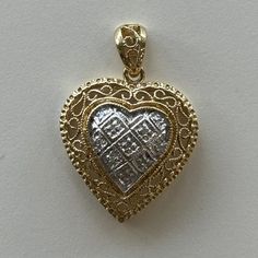 "Queen of Hearts or Queen of Diamonds? This heart shaped pendant might qualify as both. This 14K gold heart shaped pendant has lots of detail, including filigree (even on the bail), milgrain, and a diamonds in a diamond shaped setting!  The diamonds are H-I in color, and I in clarity, 0.03TCW.  Including the decorative bail, the pendant hangs 1 1/8\" x 3/4\" wide. The total weight of this piece is 3.17g." Traditional Heart Charm Jewelry For Anniversary, Heirloom Heart-shaped Jewelry With Intricate Design, Ornate Heart Pendant Necklace For Anniversary, Valentine's Day Filigree Jewelry For Anniversary, Ornate Heart Charm Jewelry For Anniversary, Elegant Filigree Heart Necklace, Heart Shaped Yellow Gold Jewelry With Intricate Design, Heart Shaped Jewelry With Intricate Design For Valentine's Day, Elegant Heart Shaped Filigree Necklace