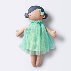 a stuffed doll wearing a green dress