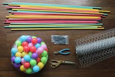 the supplies needed to make this craft include colored pencils, scissors and plastic balls