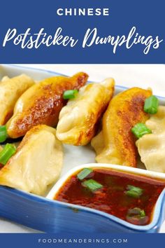 dumplings with sauce and green onions in a blue dish on a white tablecloth