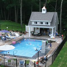 an aerial view of a backyard with a pool and hot tub in the foreground