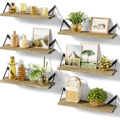 three wooden shelves with pictures and plants on them