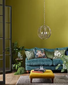 a living room with green walls and a blue couch in front of a yellow wall